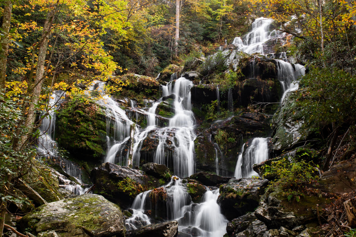 Golden autumn leaves frame Catawba Falls near Asheville, NC