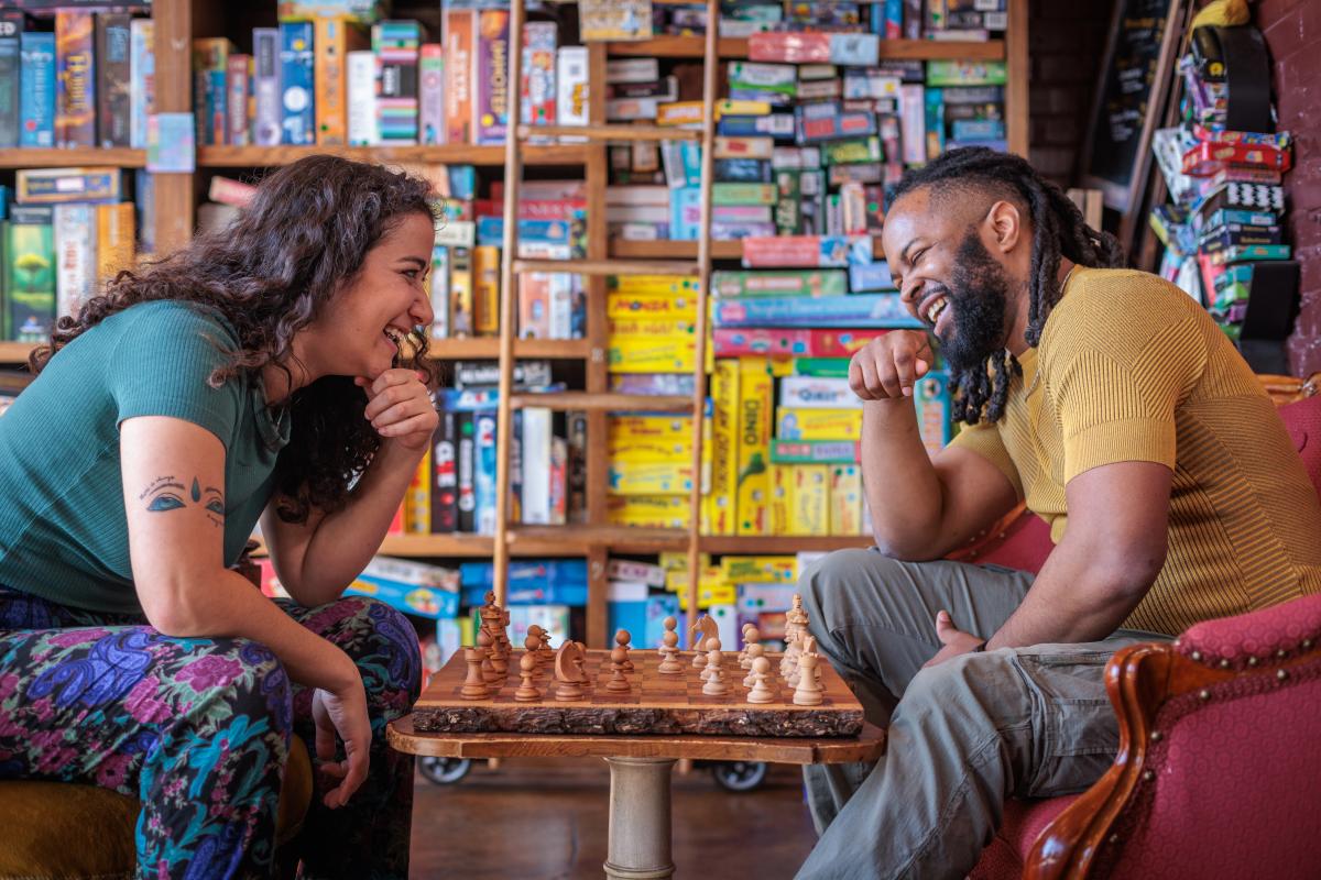 A couple playing chess in Rook & Pawn boardgame cafe.
