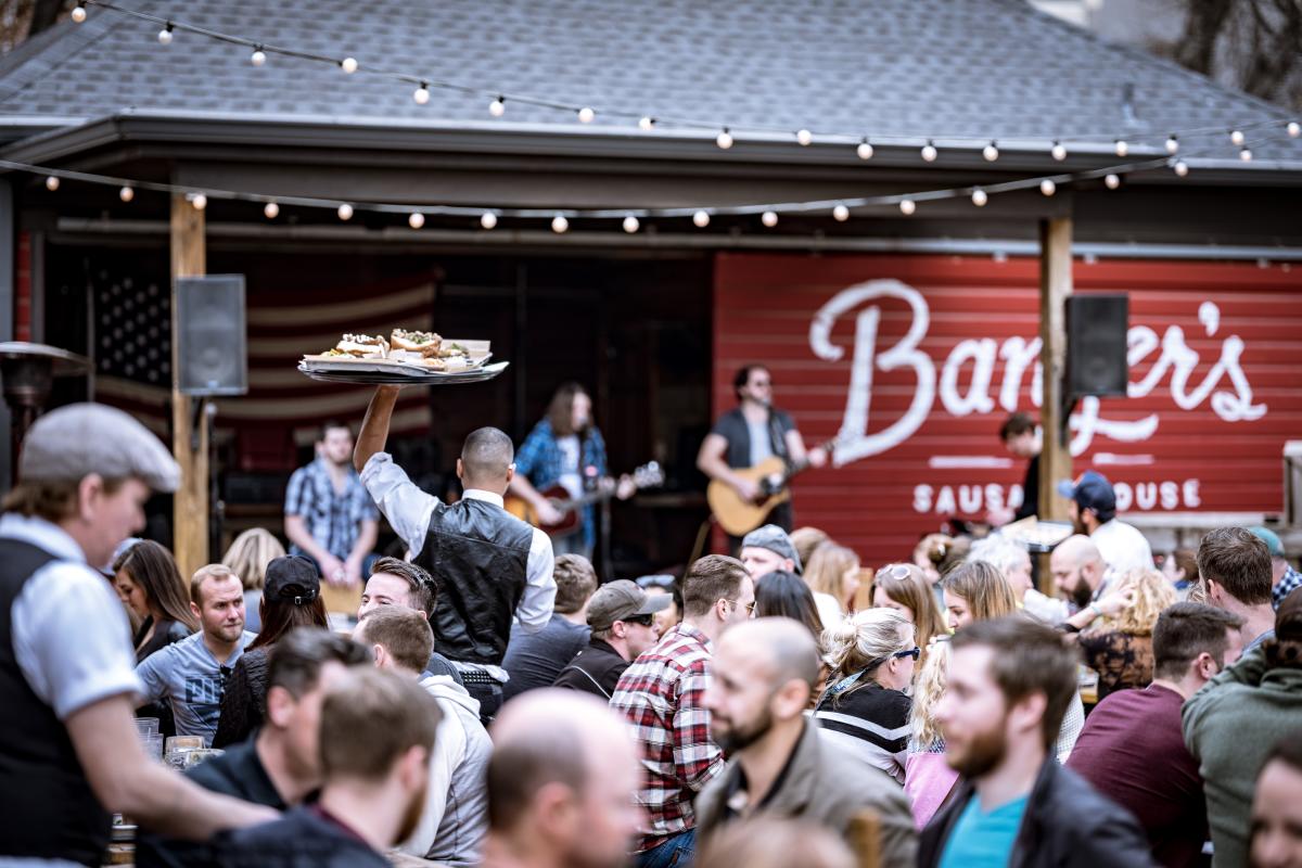 Image of the patio at Banger's with a band playing on stage in the background.