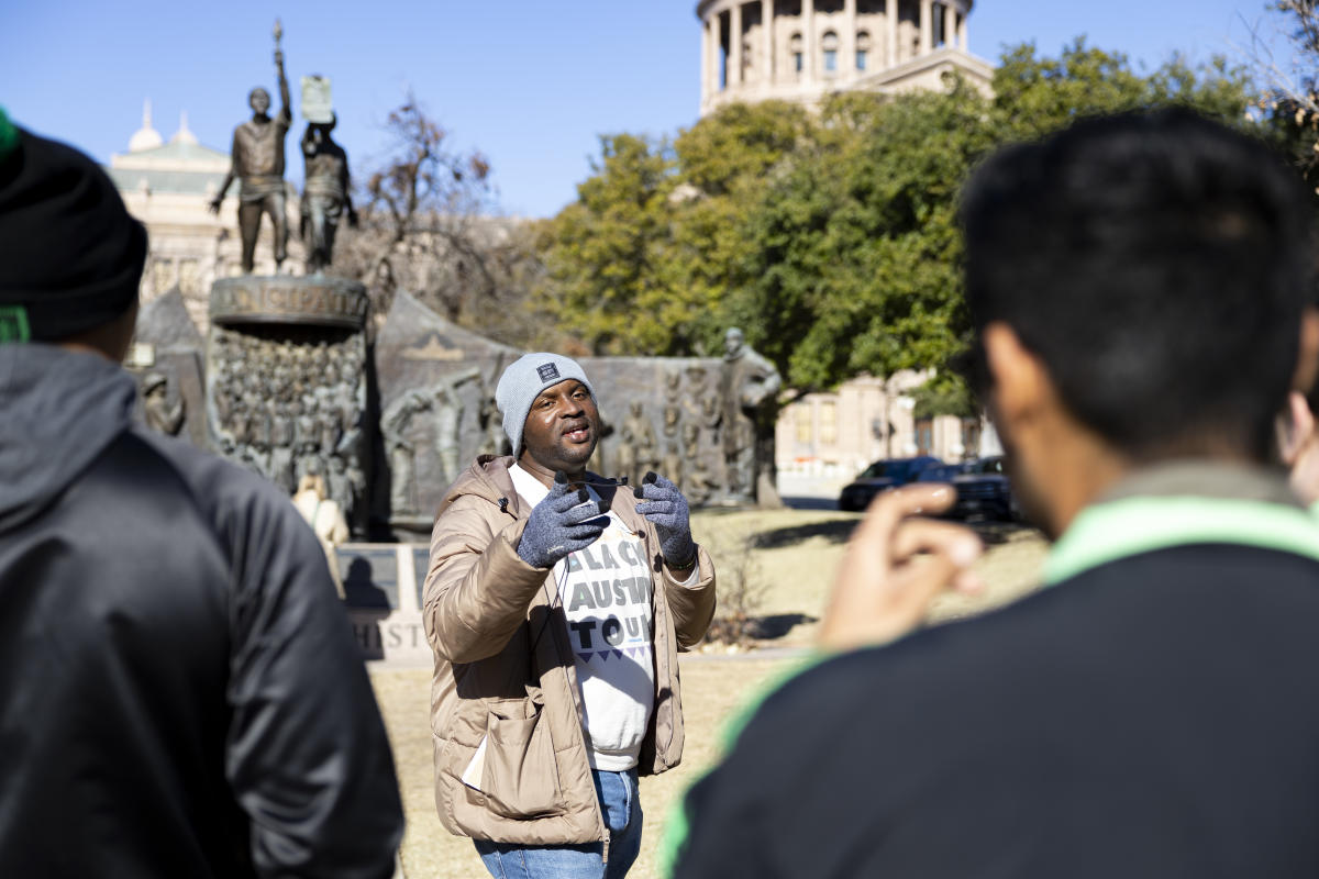 Image of Javier Wallace of Black Austin Tours giving a tour outside of the Texas State Capitol building.