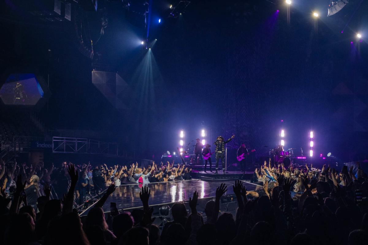 Fans reaching towards Jimmie Allen on stage at Moody Center.
