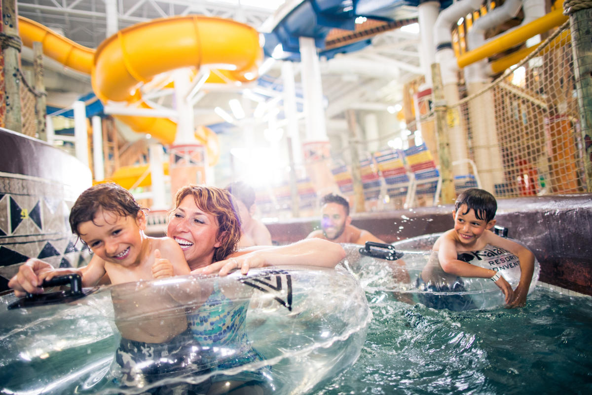 Family swimming in the indoor Lazy River at Kalahari Resort in Round Rock Texas
