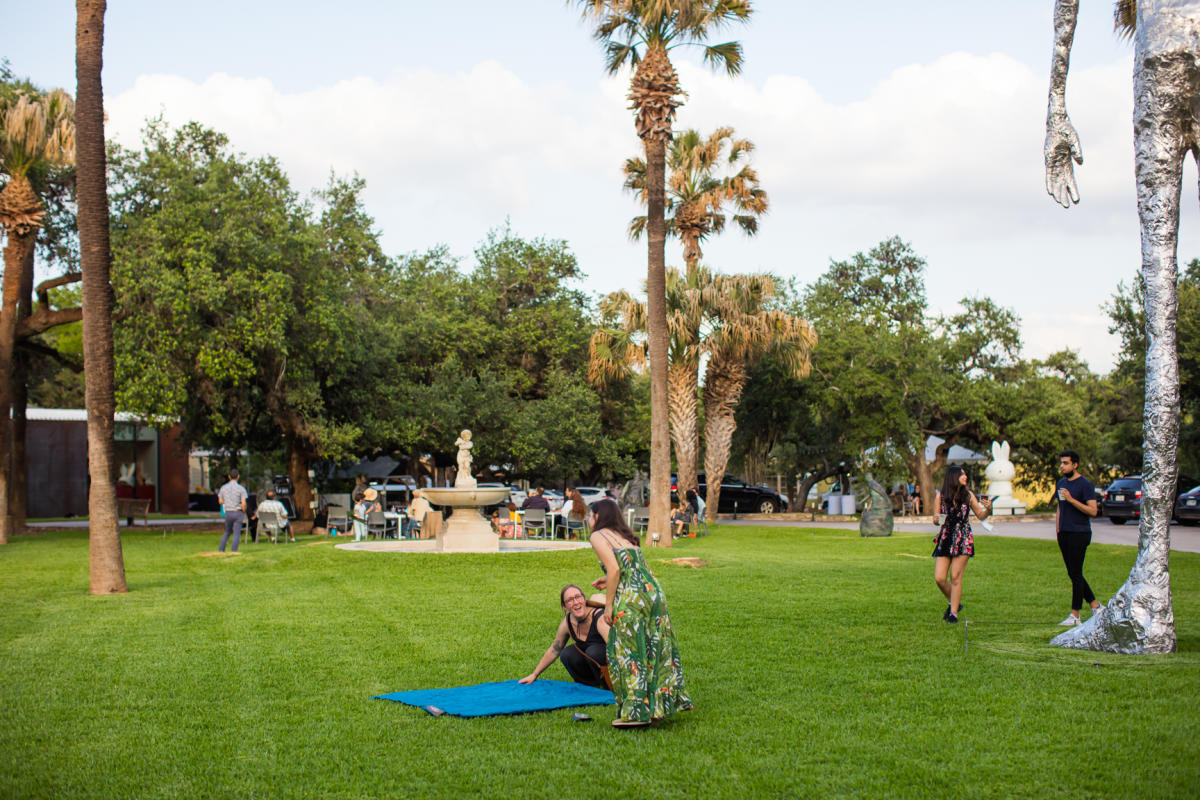 People walking around sculpture park at Laguna Gloria.