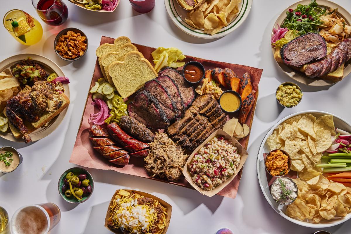 Plates filled with smoked meats and traditional and new age side dishes.