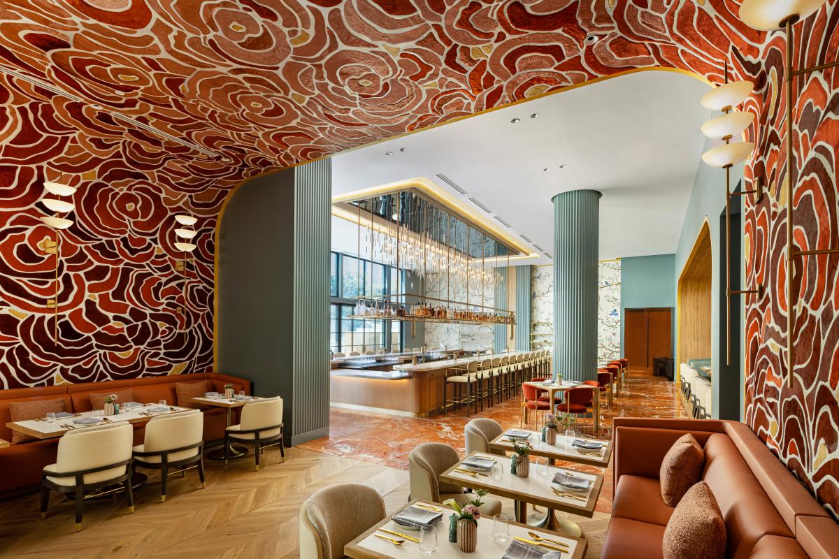 Image of the dining room at Serenade with a bright red wallpaper covering the walls of the room and ceiling.