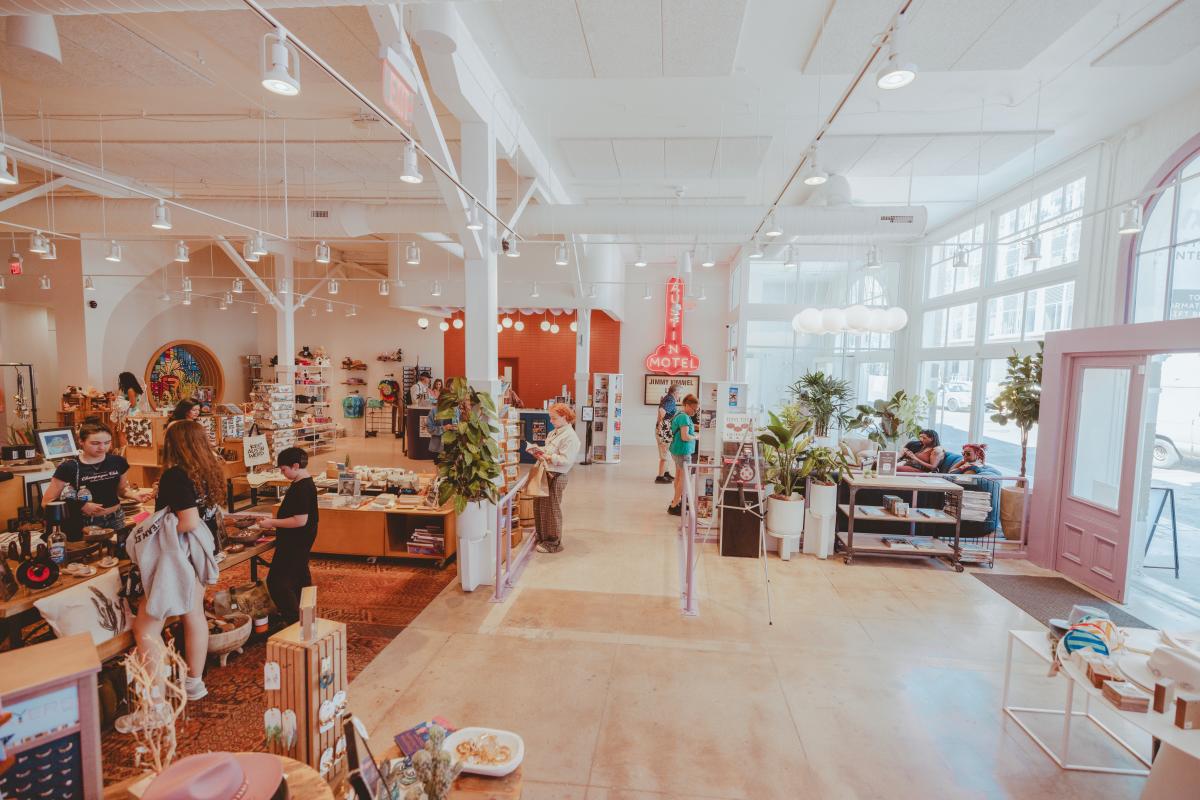 Austin Visitor Center shopping floor filled with colorful displays of merchandise and visitors browsing.
