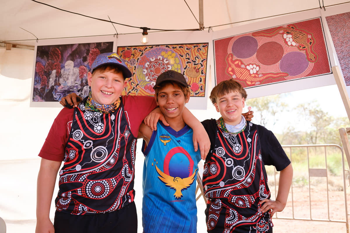 Kids at the Karijini Experience with artworks hanging in the background