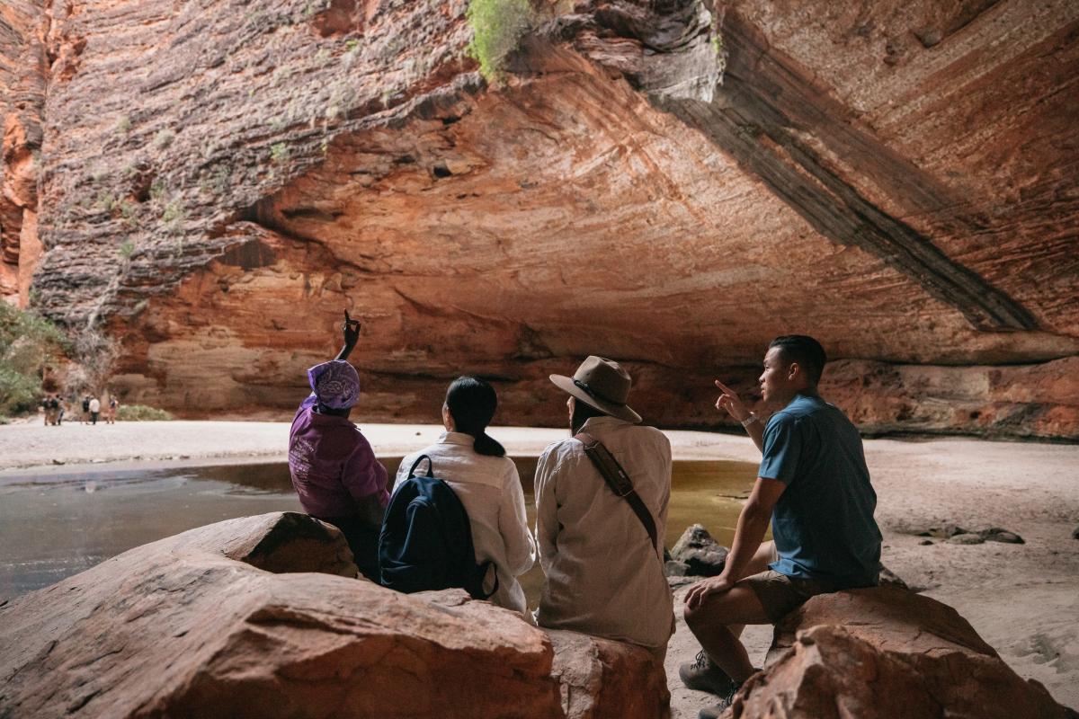 Tour guests listen to tour guide Bec Sampi with Kingfisher Tours in Cathedral Gorge, Purnululu National Park