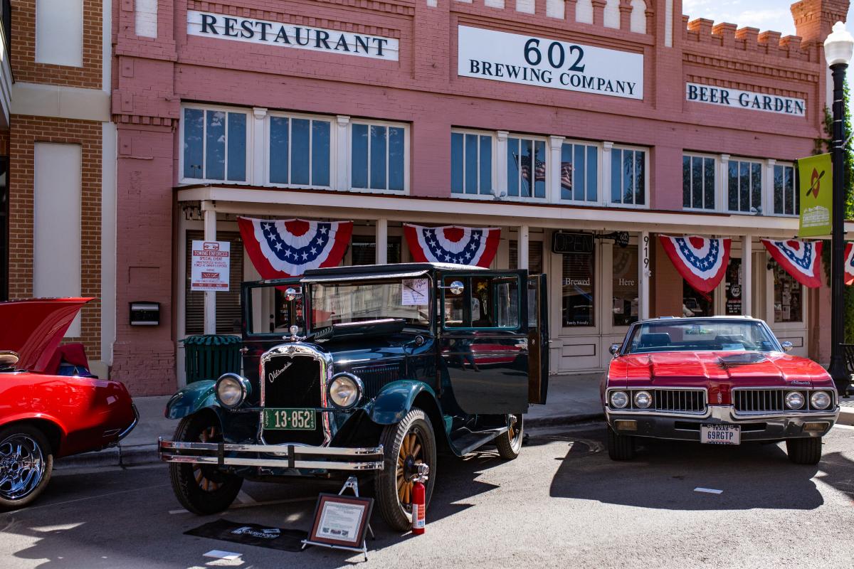 602 storefront with vintage cars