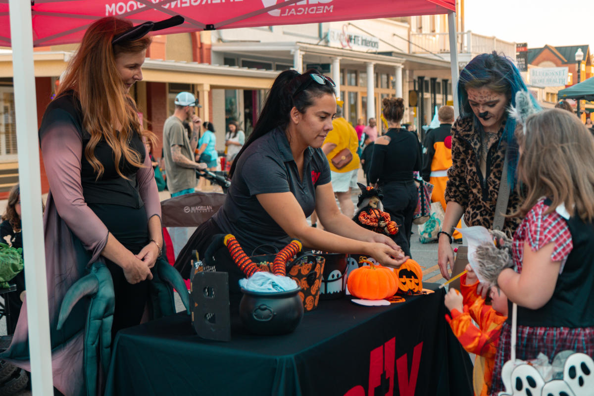 Community group handing out candy at boo bash in bastrop