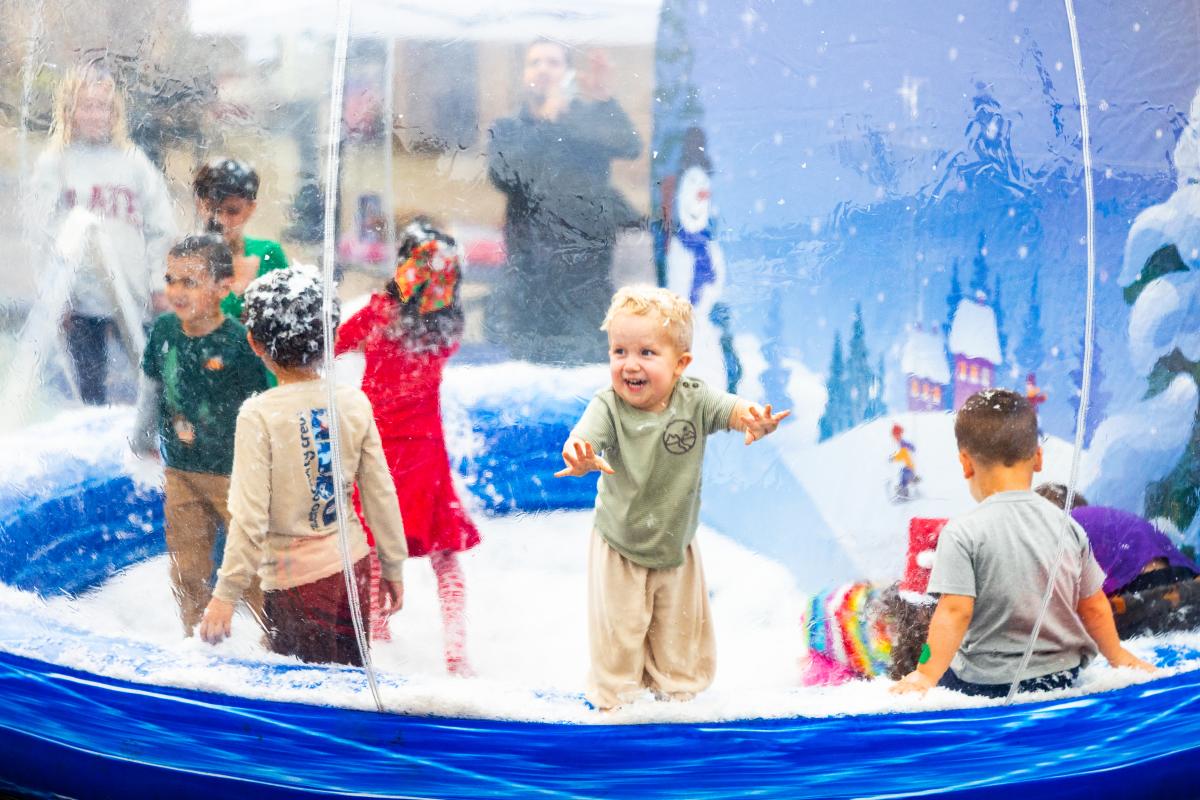 Baby playing in inflatable snow globe