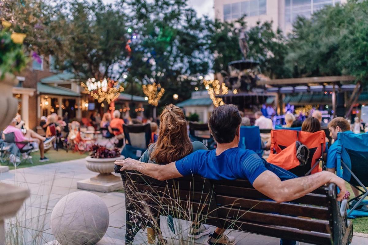 Man and woman watching music performance at Perkins Rowe.
