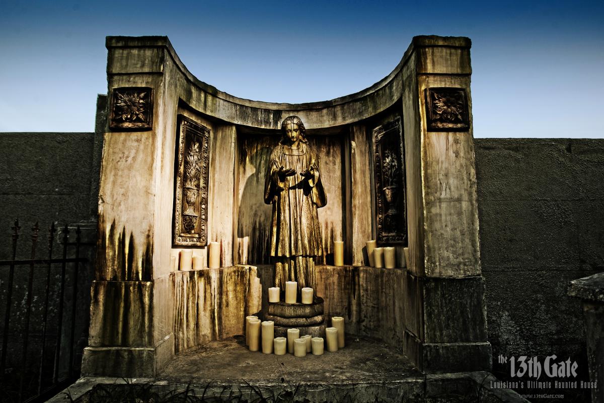 Angel statue surrounded by candles at the 13th Gate