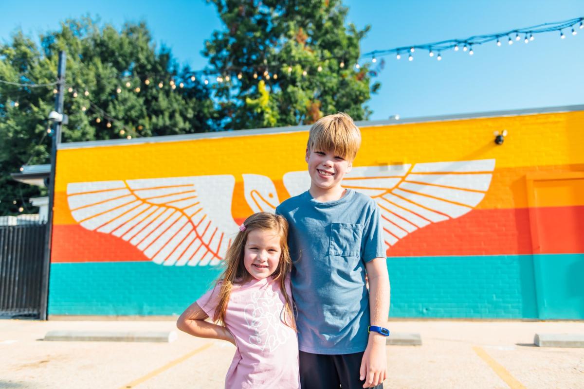 two kids in front of mural in Baton Rouge