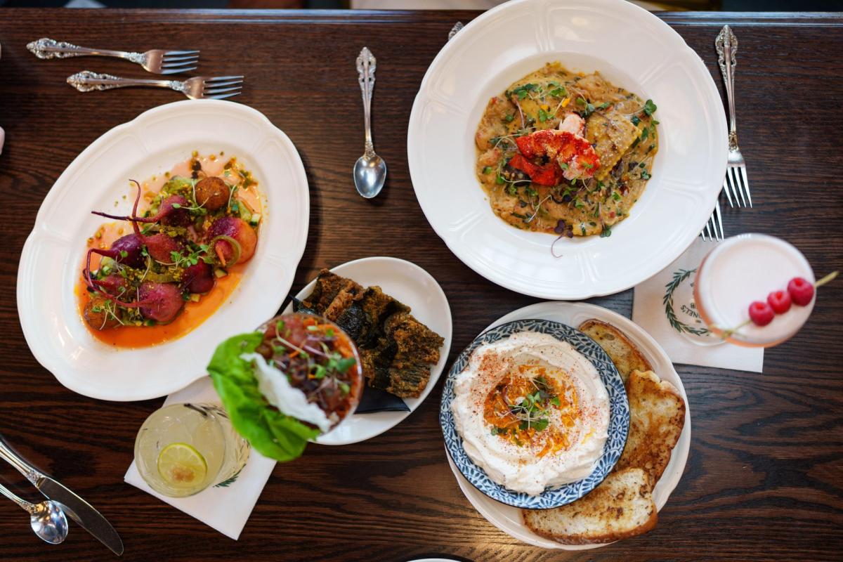Romantic date night dishes and cocktails displayed on a restaurant table in Baton Rouge.
