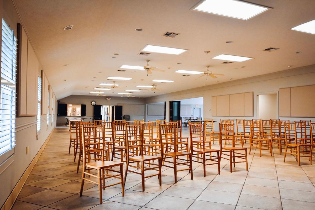 Empty Meeting Area With Stacked Wooden Chairs