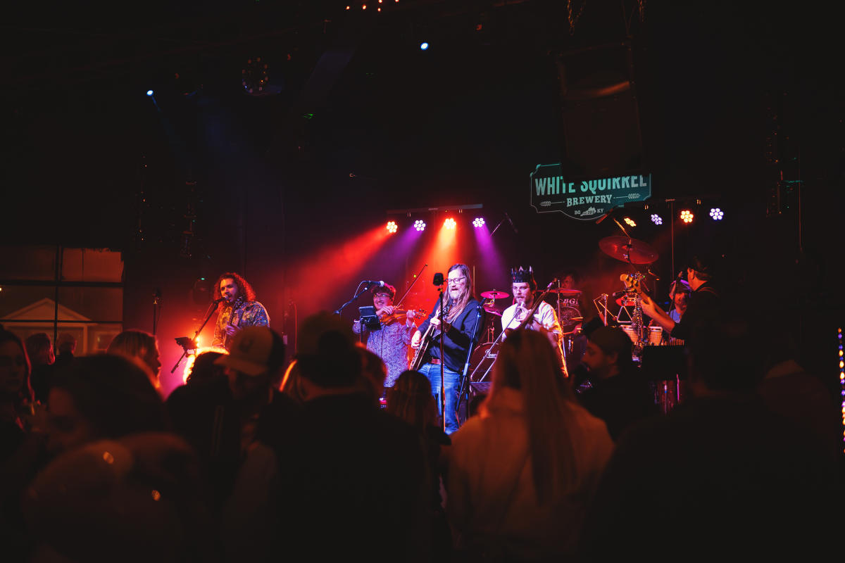 The band Fatbox performing to a crowd at White Squirrel Brewery