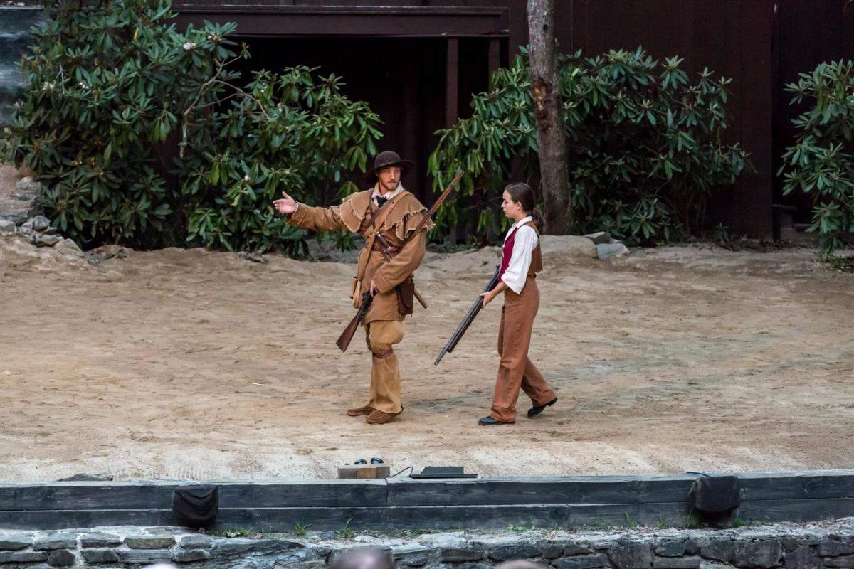 Daniel Boone walks with a young boy during "Horn in the West" an Outdoor Drama in Boone, NC.