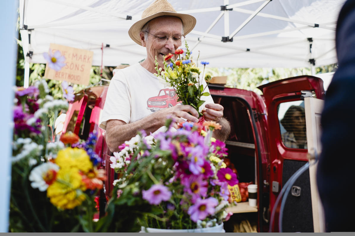 Boulder Farmers Market Man with flowers