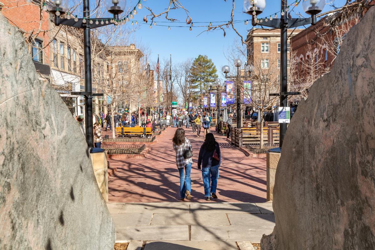 A bustling sunny winter Pearl Street scene in Boulder, CO