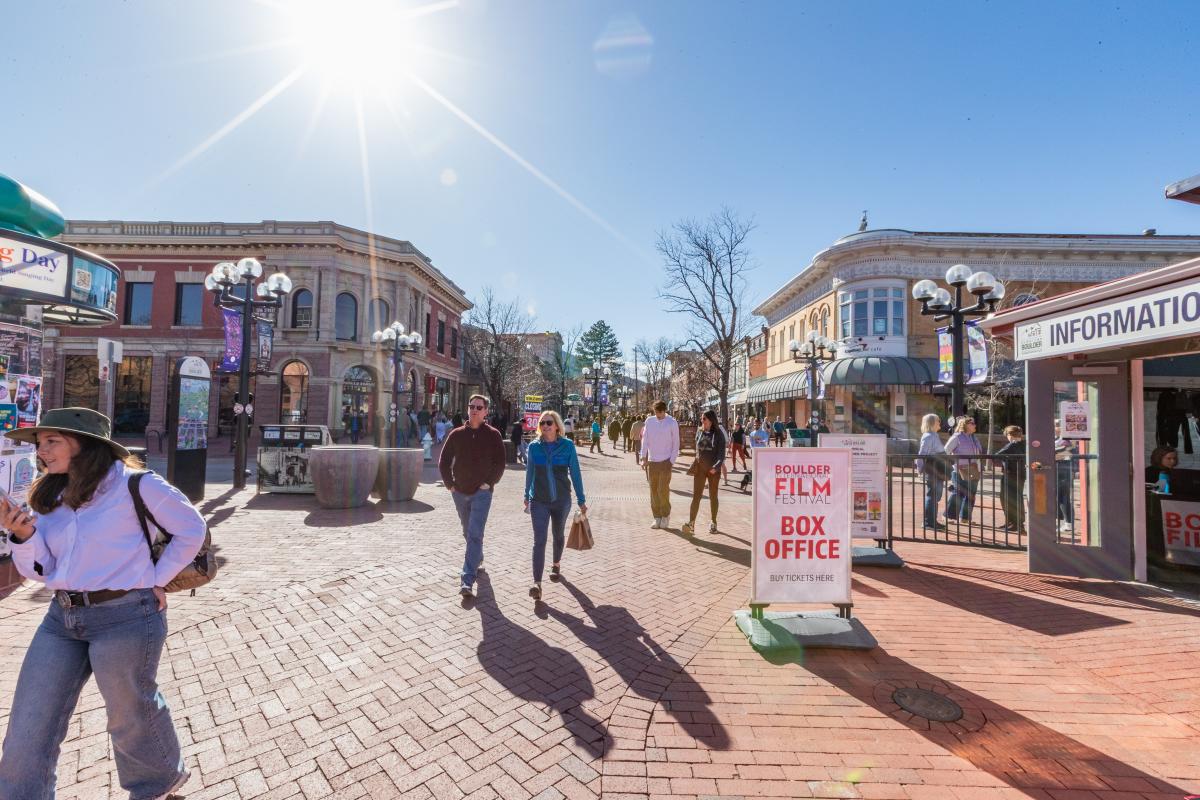 People walking on the brick-lined Pearl Street in Boulder on a sunny winter day