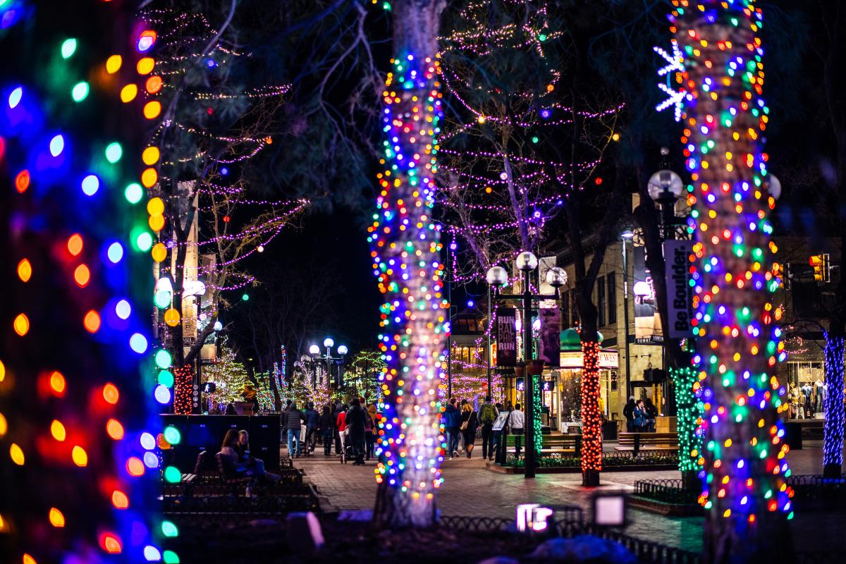 Downtown Boulder lit up with twinkle light-covered trees for the Snow Much Fun event.