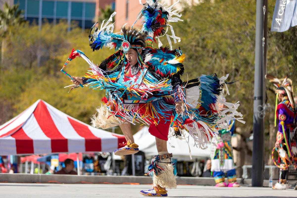 a Native American hoop dancer performance at an outdoor event