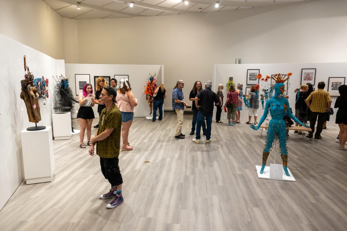 people viewing artwork on display at The Gallery at the Chandler Center for the Arts