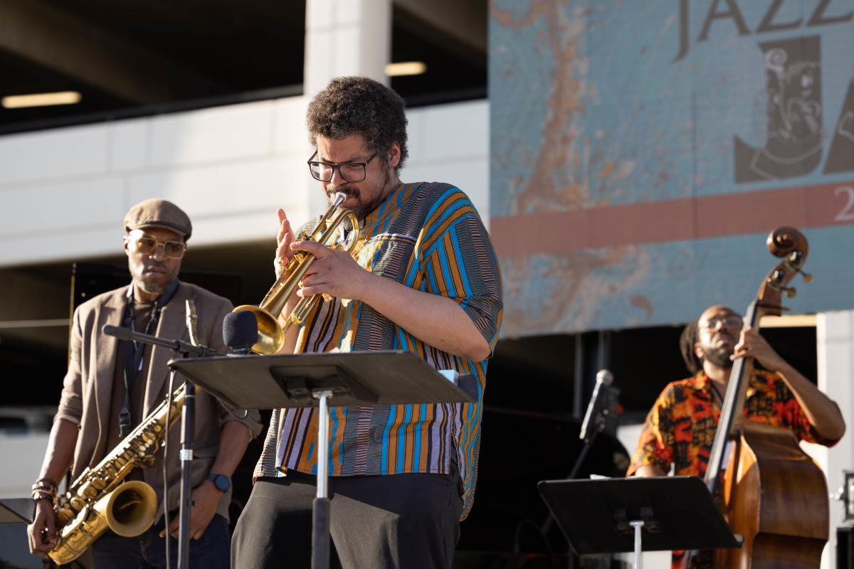 3 band members playing instruments on the main stage at the Chandler Jazz Festival.