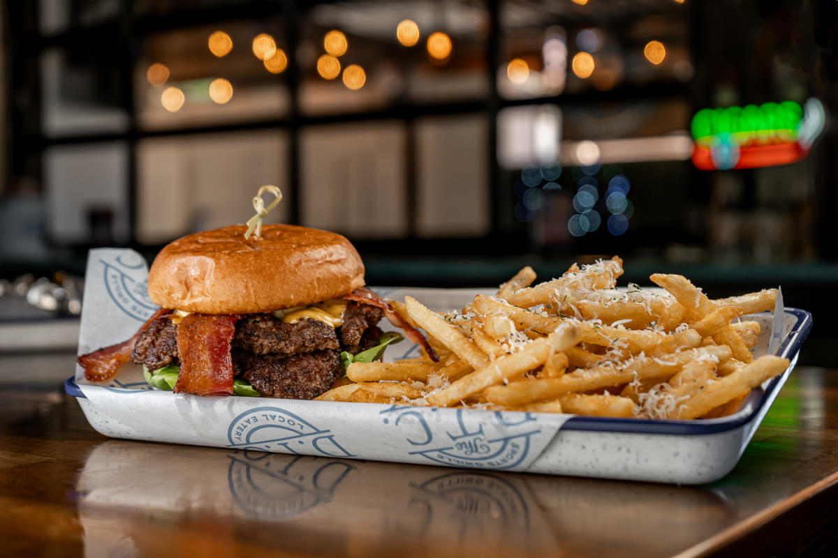 a plate with a double bacon cheeseburger and french fries