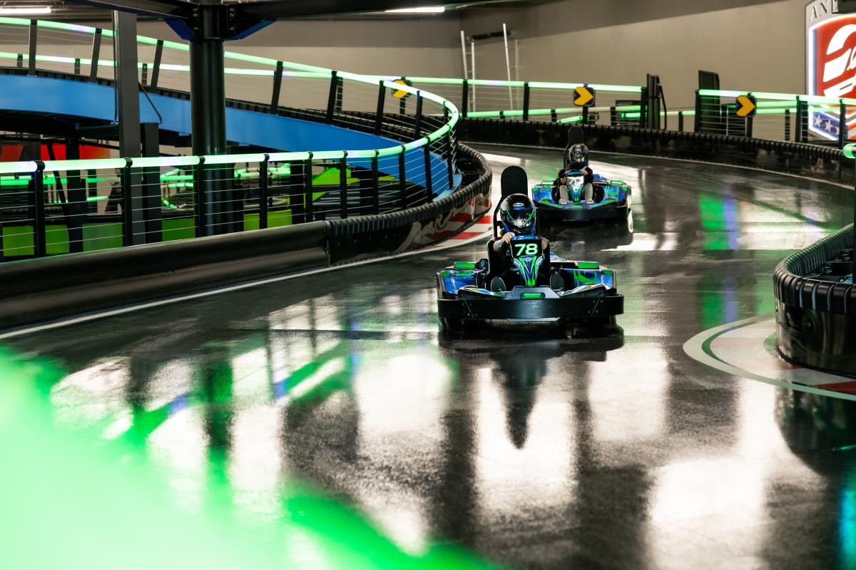 Kids racing on go-kart track.