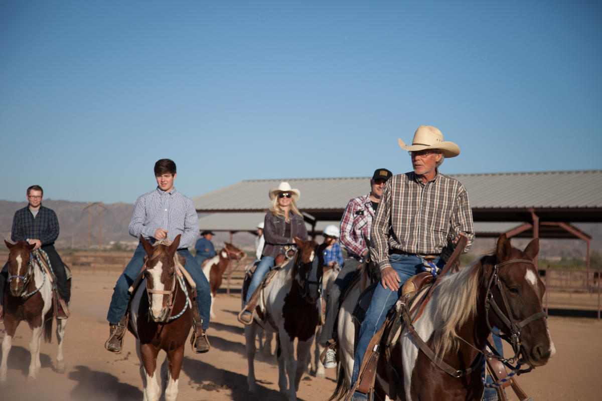 Group Of People Horseback Riding At Koli Equestrian Center In Chandler, AZ