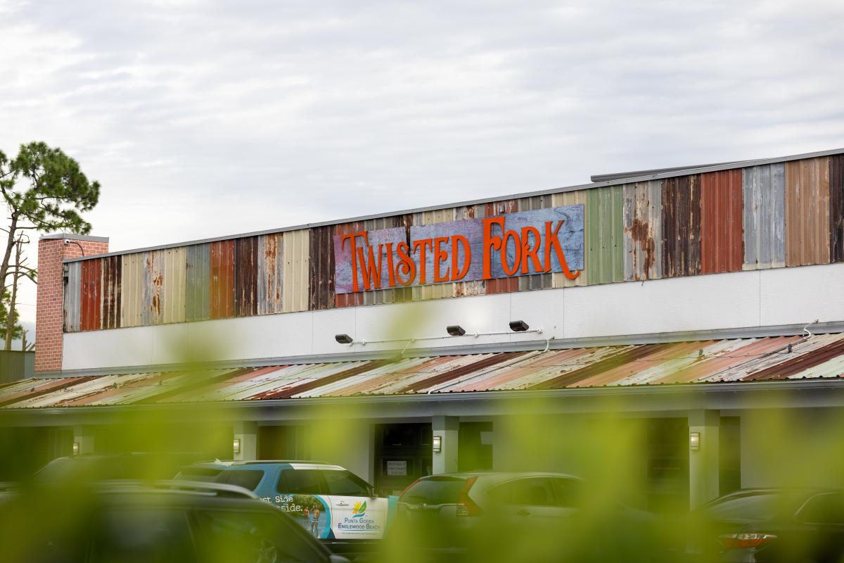 The rustic exterior of Twisted Fork restaurant in Port Charlotte, Florida.