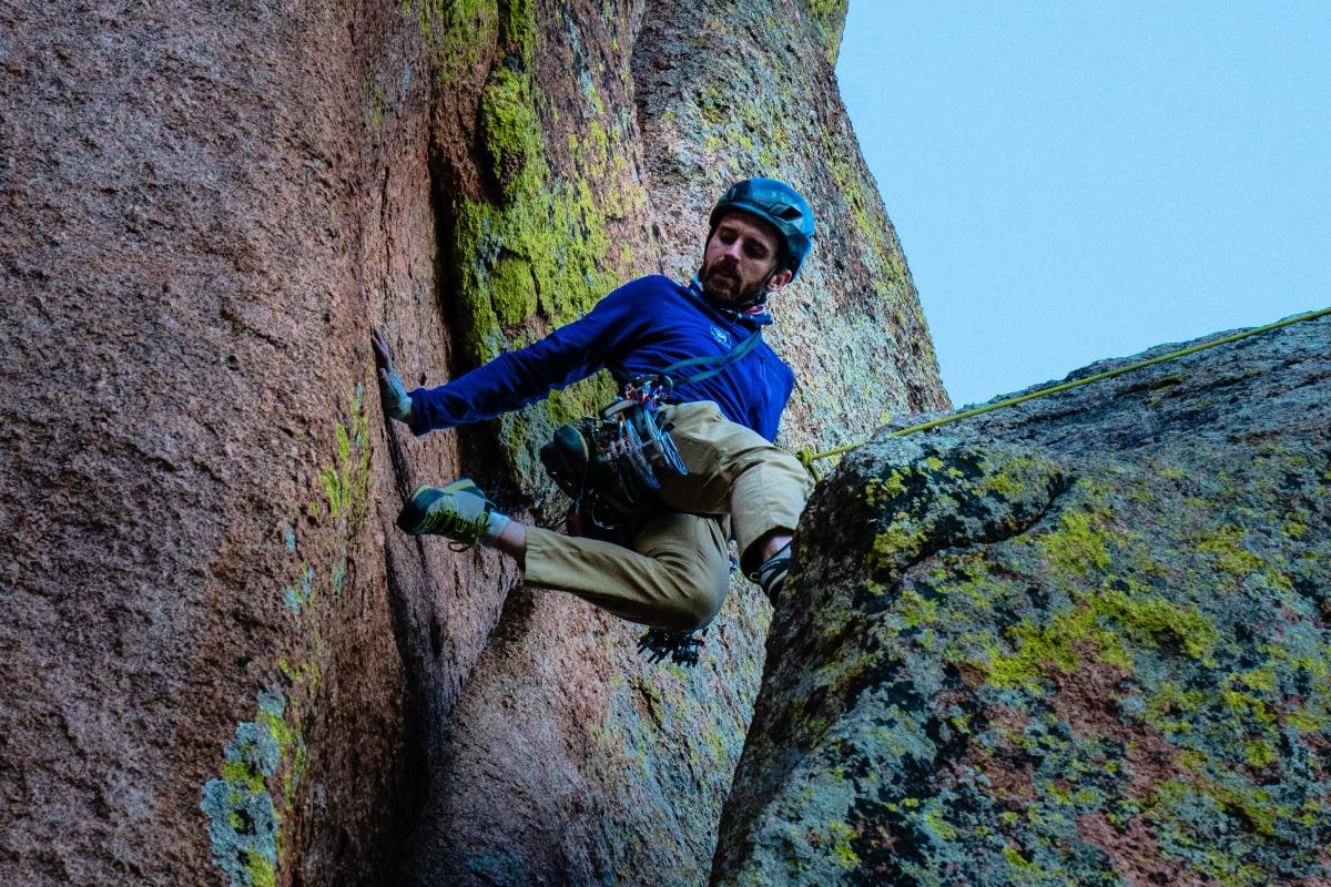 A scaling a cliff face at Vedauwoo Recreation Area near Turtle Rock.