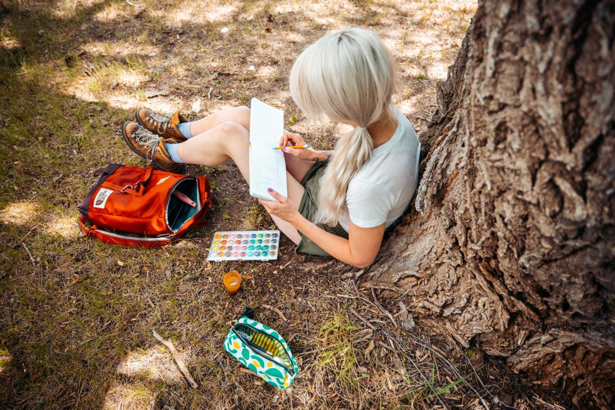 Woman painting in watercolor outside
