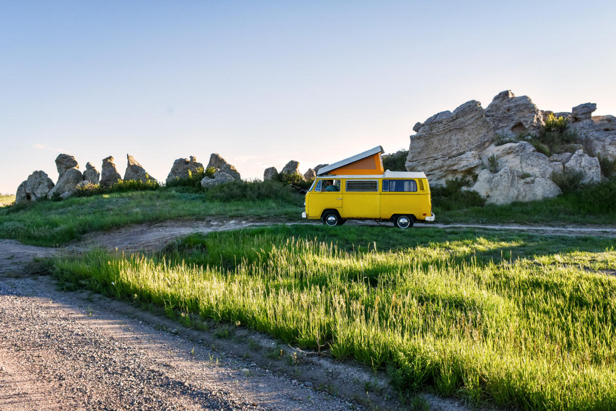 Image of a yellow VW bus in a Wyoming landscape