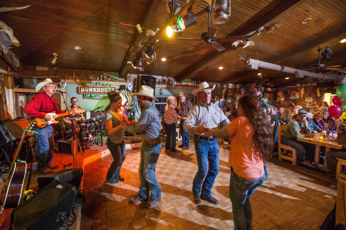 People dancing to a live country band at The Bunkhouse, a popular live music venue in Cheyenne.