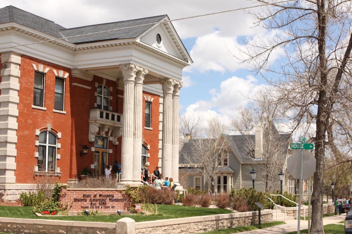 The Historic Governors Mansion in Wyoming, surrounded by vibrant community activity, a premier destination for exploring top historical things to do.