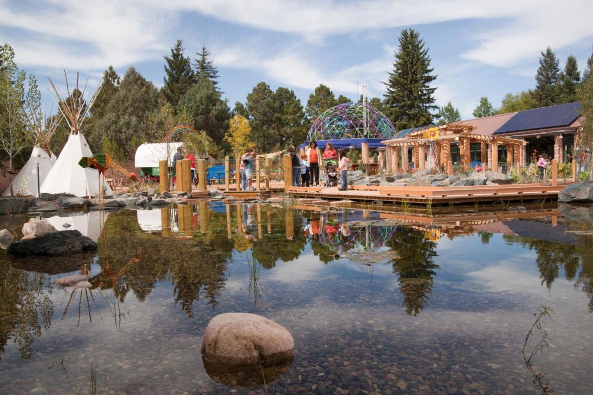 Families engaged in interactive and educational outdoor activities at Paul Smith Children’s Village in Cheyenne, WY.
