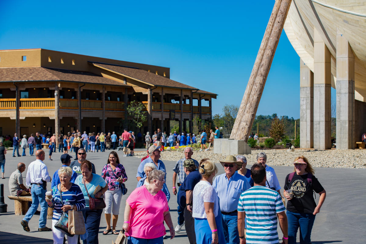 Image is of the crowd walking around the Ark with the Ark to the right.