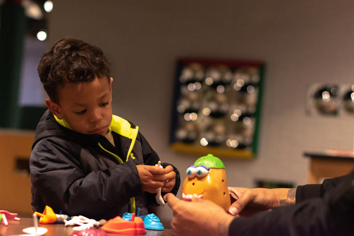 dad and kid building a craft together