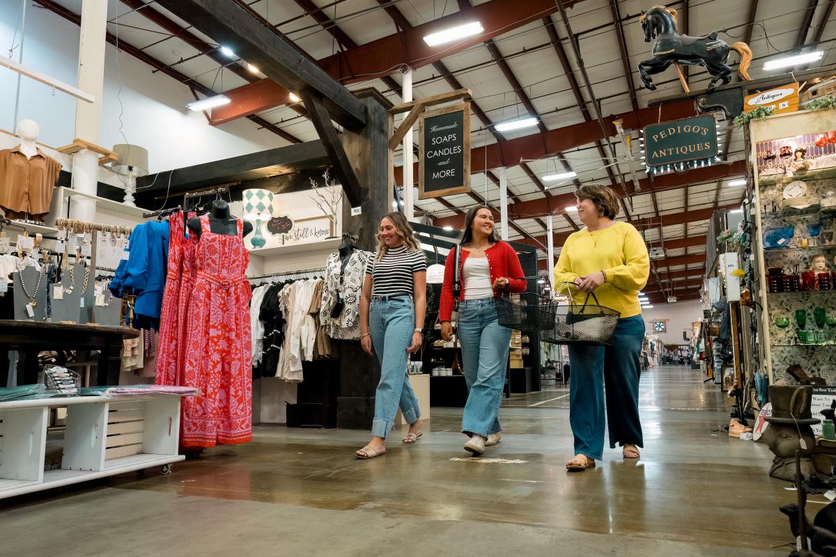 three ladies walking in a large shopping complex
