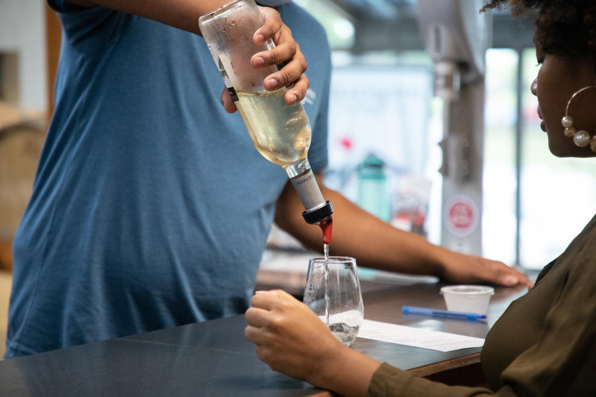 pouring mom a sample tasting at a winery