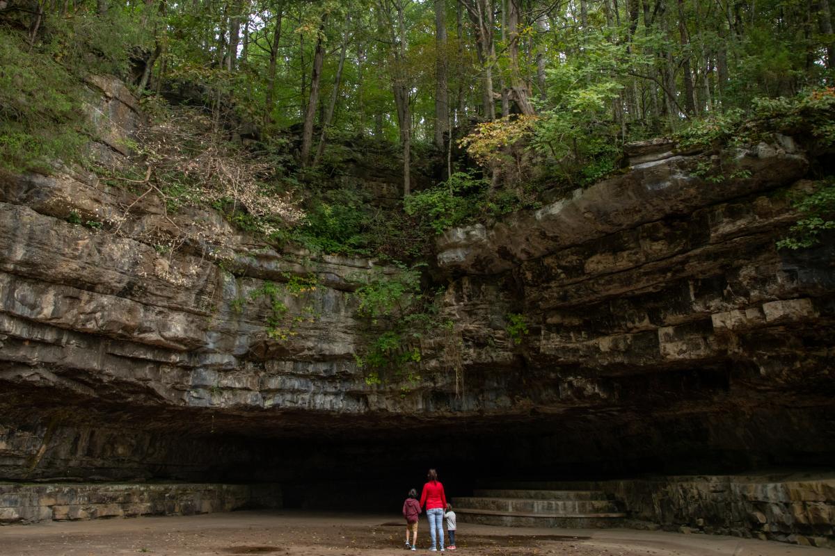 family outside a large cave