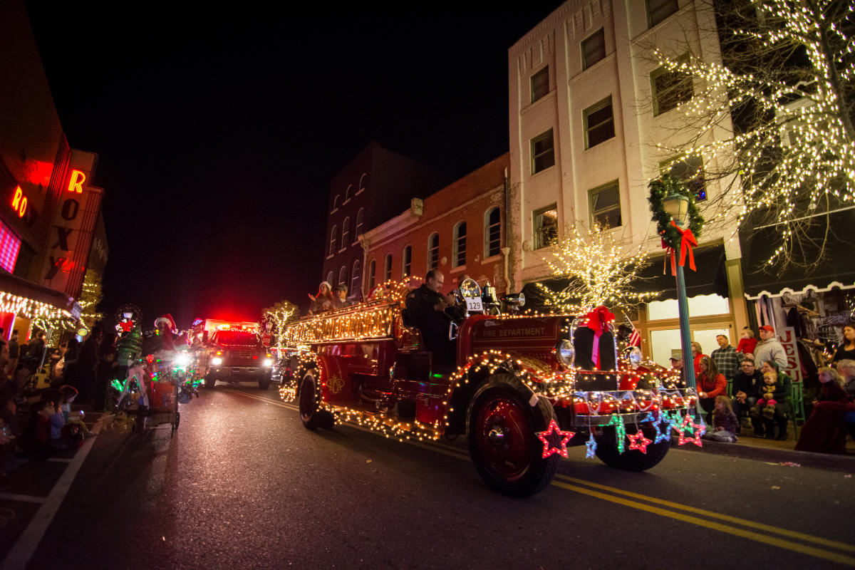lighted vehicles in a Christmas parade