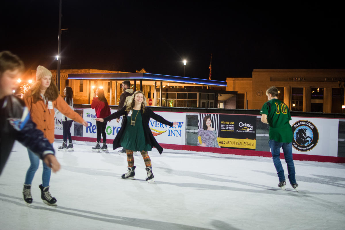 skaters on an outdoor ice rink