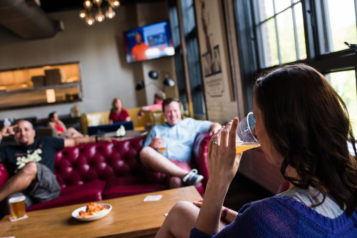 three people  hanging out in a pub