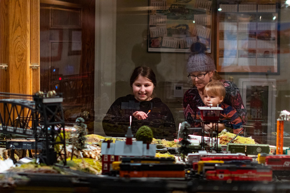 family looking at a large model train display