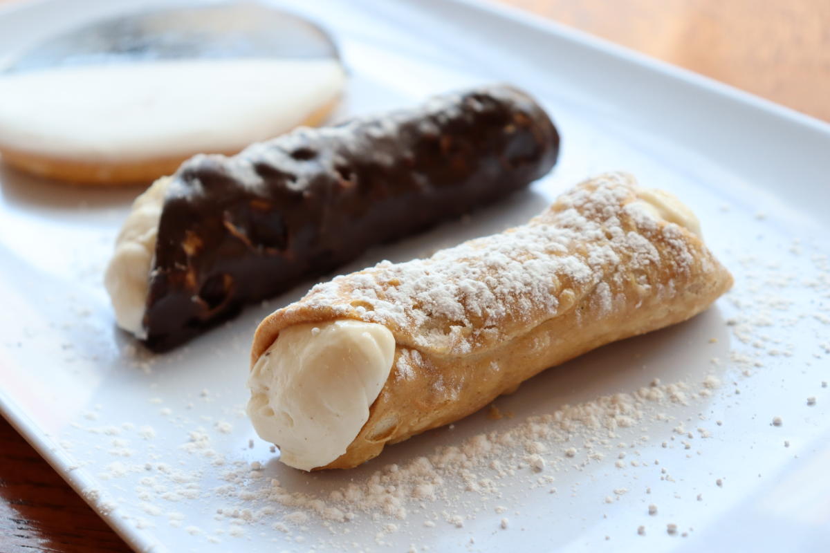 two canolli's and a cookie on a platter