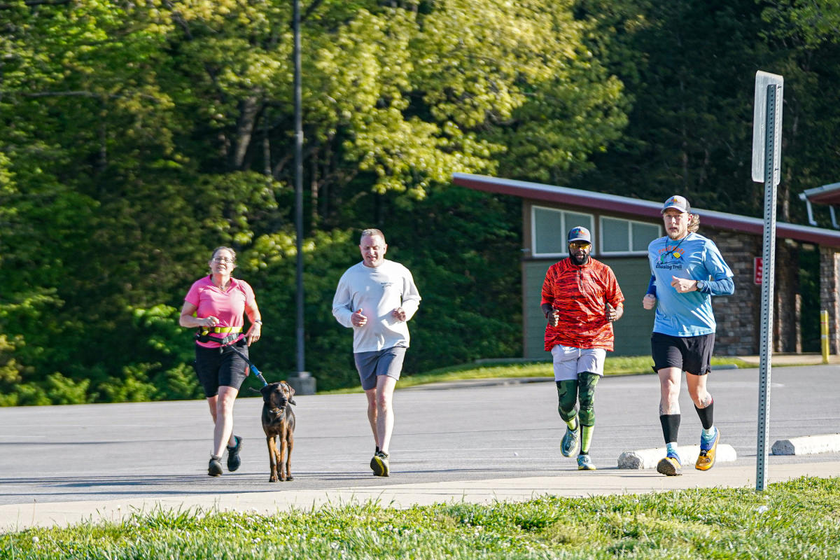 group of runners with a dog